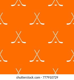Crossed hockey sticks and puck pattern repeat seamless in orange color for any design. Vector geometric illustration