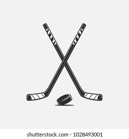 Crossed hockey sticks and puck vector illustration