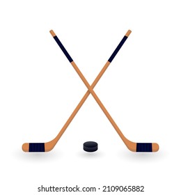 Crossed ice hockey sticks and puck. Symbol of winter game, active recreation, leisure activity. Vector illustration of wooden equipment isolated on white background.