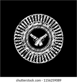 crossed pistols icon inside chalkboard emblem on black board