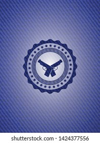crossed pistols icon inside emblem with denim high quality background
