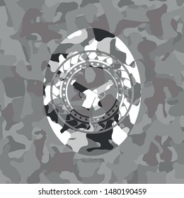 crossed pistols icon inside grey camo emblem