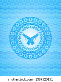 crossed pistols icon inside light blue water wave emblem.