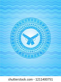 crossed pistols icon inside sky blue water wave badge background.