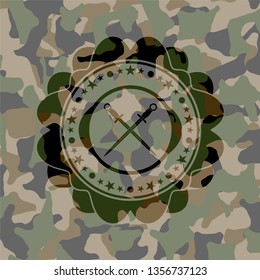 crossed swords icon inside camouflaged emblem