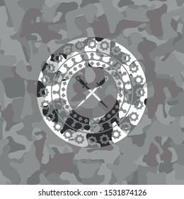 crossed swords icon inside grey camo emblem