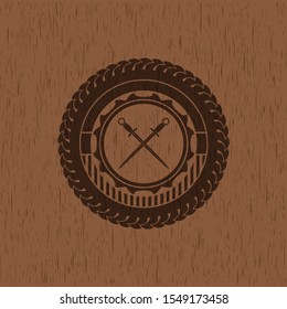 crossed swords icon inside wooden emblem. Vintage.