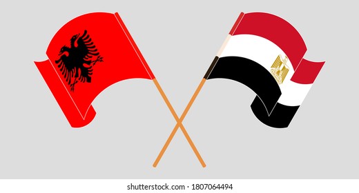 Crossed and waving flags of Albania and Egypt