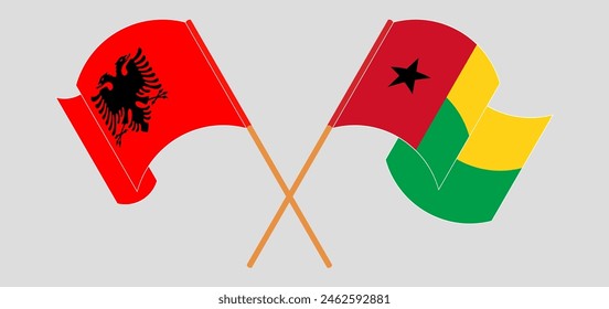 Crossed and waving flags of Albania and Guinea-Bissau. Vector illustration
