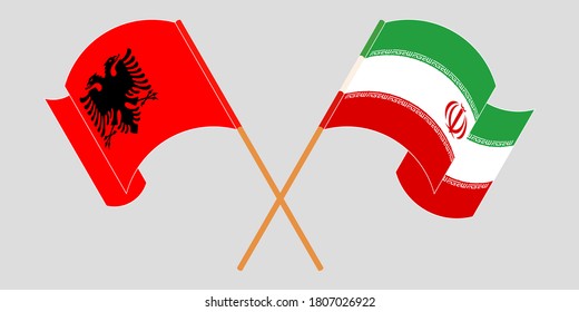 Crossed and waving flags of Albania and Iran