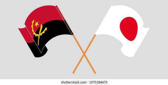 Crossed and waving flags of Angola and Japan
