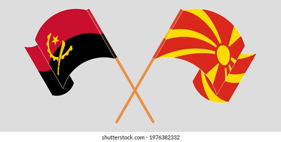 Crossed and waving flags of Angola and North Macedonia
