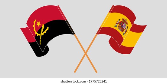 Crossed and waving flags of Angola and Spain