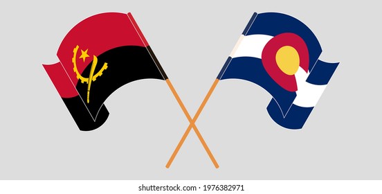 Crossed and waving flags of Angola and The State of Colorado