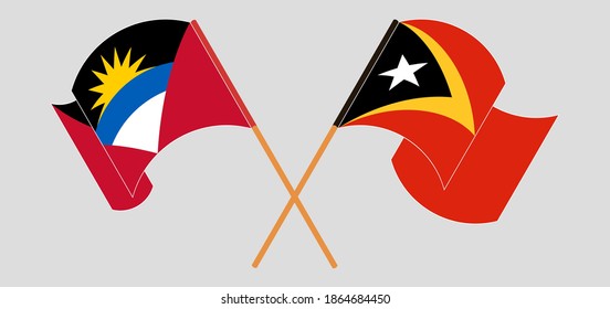 Crossed and waving flags of Antigua and Barbuda and East Timor