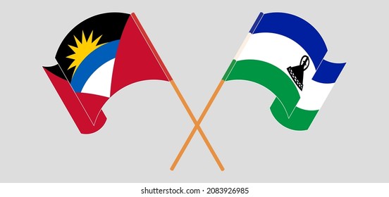 Crossed and waving flags of Antigua and Barbuda and Kingdom of Lesotho. Vector illustration
