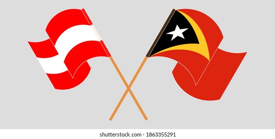 Crossed and waving flags of Austria and East Timor