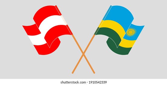 Crossed and waving flags of Austria and Rwanda