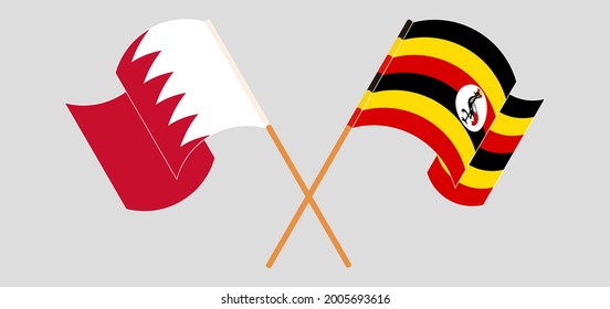 Crossed and waving flags of Bahrain and Uganda