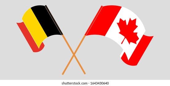 Crossed and waving flags of Belgium and Canada
