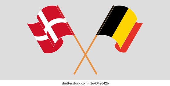 Crossed and waving flags of Belgium and Denmark