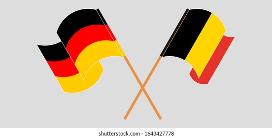 Crossed and waving flags of Belgium and Germany