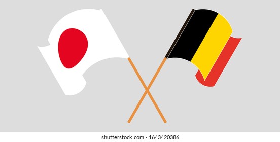 Crossed and waving flags of Belgium and Japan