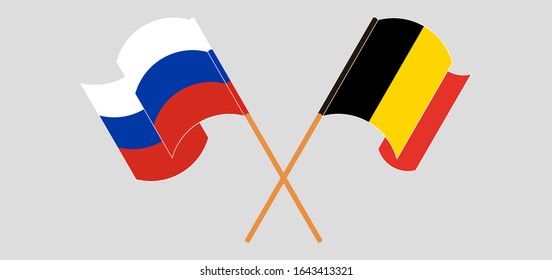 Crossed and waving flags of Belgium and Russia