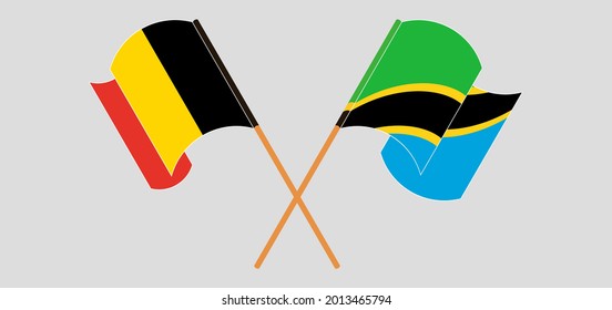 Crossed and waving flags of Belgium and Tanzania