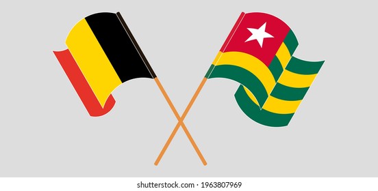 Crossed and waving flags of Belgium and Togo