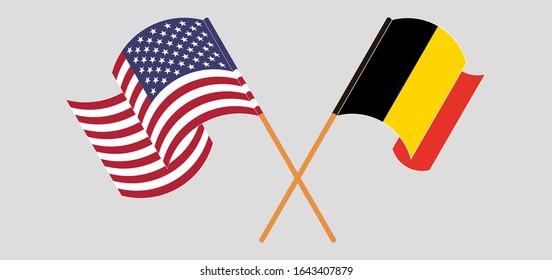 Crossed and waving flags of Belgium and the USA