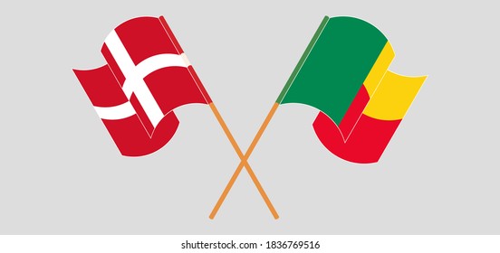 Crossed and waving flags of Benin and Denmark