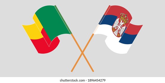 Crossed and waving flags of Benin and Serbia
