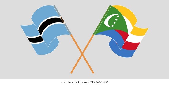 Crossed and waving flags of Botswana and Comoros. Vector illustration
