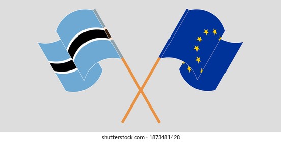 Crossed and waving flags of Botswana and the European Union