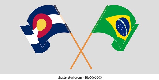 Crossed and waving flags of Brazil and The State of Colorado