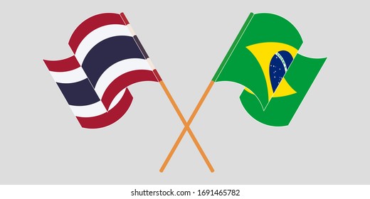 Crossed and waving flags of Brazil and Thailand