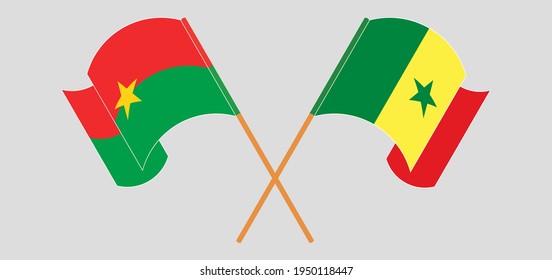 Crossed and waving flags of Burkina Faso and Senegal