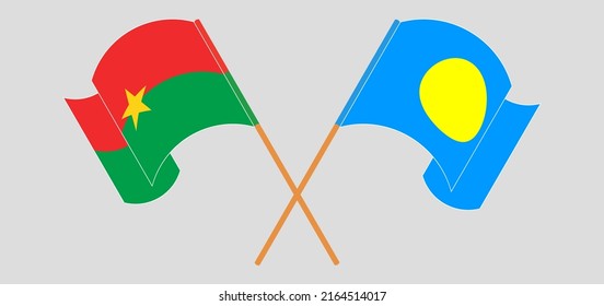 Überquerte und schwellende Flaggen von Burkina Faso und Palau. Vektorgrafik
