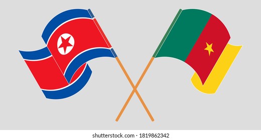 Crossed and waving flags of Cameroon and North Korea