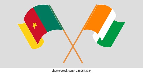 Crossed and waving flags of Cameroon and Republic of Ivory Coast
