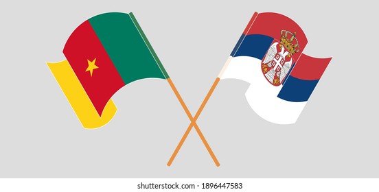 Crossed and waving flags of Cameroon and Serbia