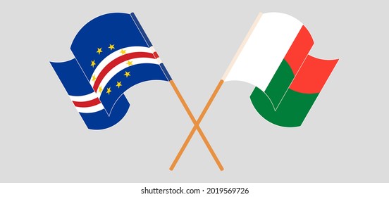 Crossed and waving flags of Cape Verde and Madagascar