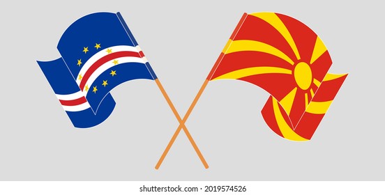 Crossed and waving flags of Cape Verde and North Macedonia