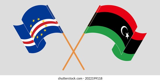 Crossed and waving flags of Cape Verde and Libya