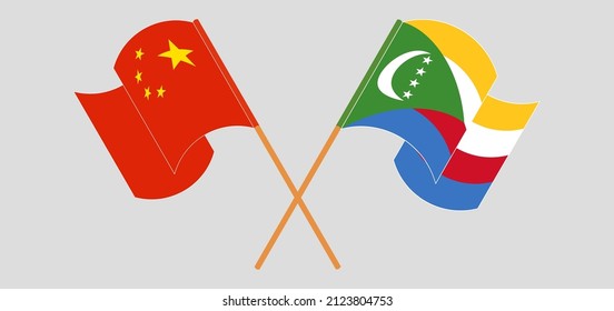 Crossed and waving flags of China and Comoros. Vector illustration
