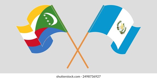 Crossed and waving flags of the Comoros and Republic of Guatemala. Vector illustration
