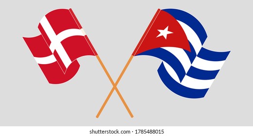 Crossed and waving flags of Cuba and Denmark