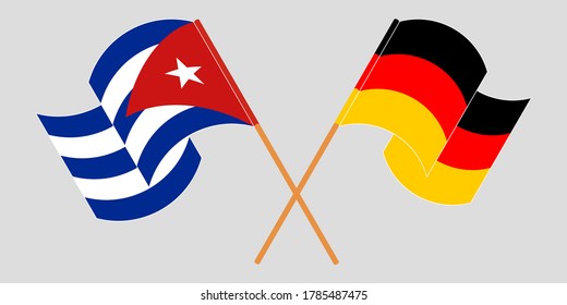 Crossed and waving flags of Cuba and Germany