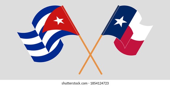 Banderas cruzadas y ondeando banderas de Cuba y del Estado de Texas